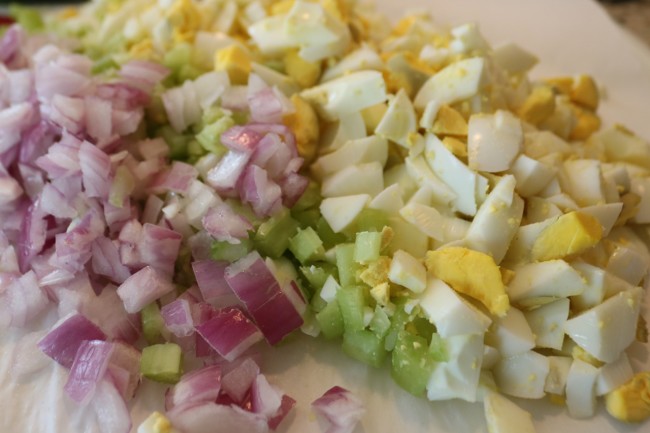 Chop hard boiled eggs celery and red onion for an easy egg salad sandwich recipe